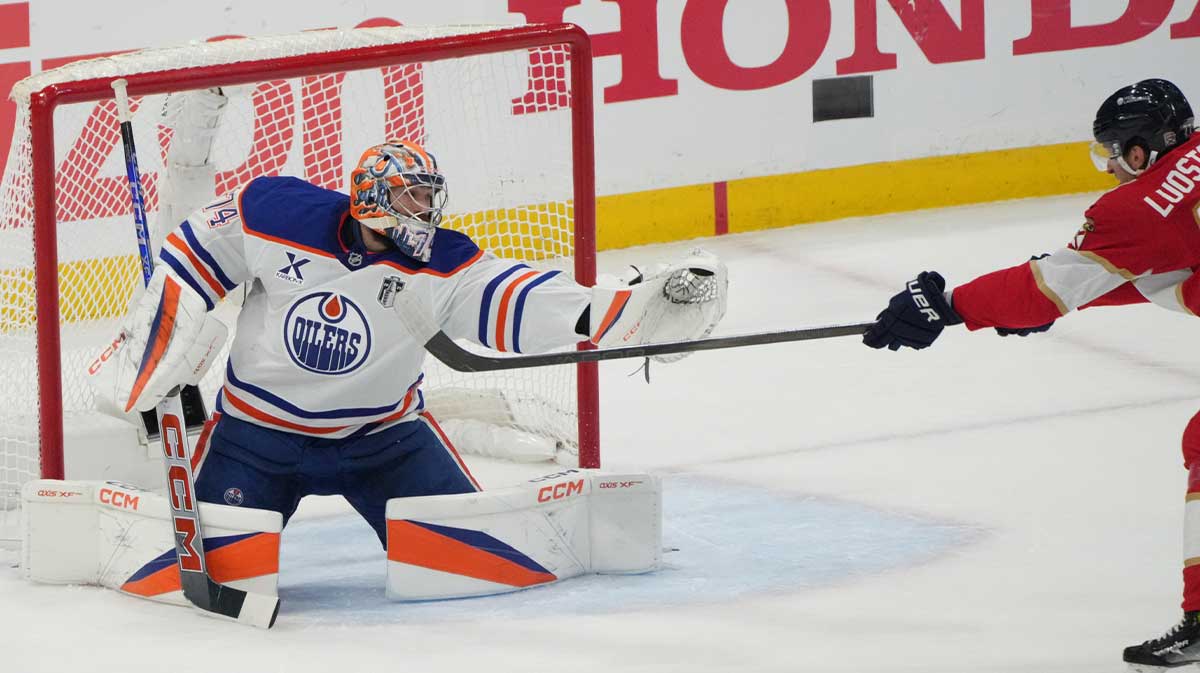 Edmonton Oilers goaltender Stuart Skinner (74) blocks a shot by Florida Panthers forward Eetu Luostarinen (27) during the first period in game four of the 2025 Stanley Cup Final at Amerant Bank Arena.