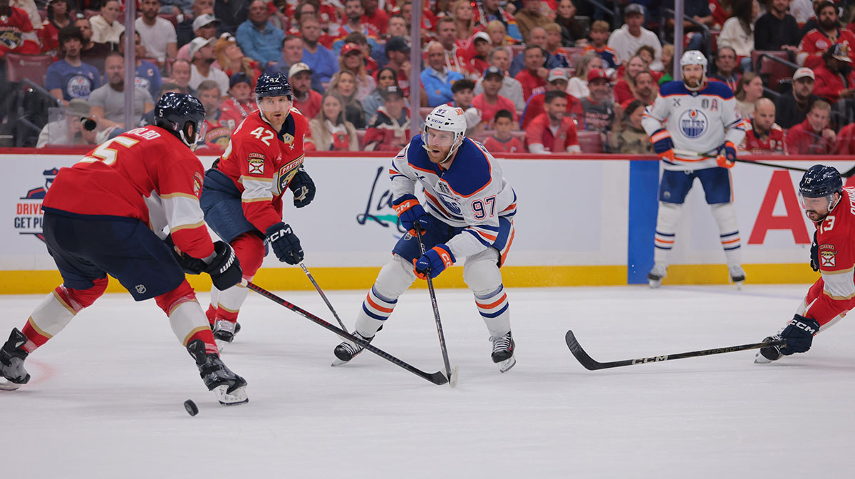 Florida Panthers defenseman Aaron Ekblad (5) and defenseman Gustav Forsling (42) defend against Edmonton Oilers center Connor McDavid (97) during the first period in game three of the 2025 Stanley Cup Final at Amerant Bank Arena.