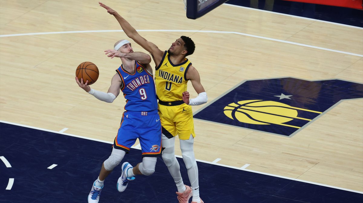 Oklahoma City Thunder guard Alex Caruso (9) drives to the hoop past Indiana Pacers guard Tyrese Haliburton (0) during the fourth quarter of game four of the 2025 NBA Finals at Gainbridge Fieldhouse.