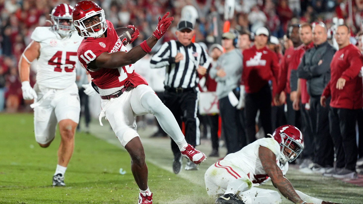 Oklahoma Sooners linebacker Kip Lewis (10) returns an interception for a touchdown in front of Alabama Crimson Tide tight end Robbie Ouzts (45) and quarterback Jalen Milroe (4) during a college football game between the University of Oklahoma Sooners (OU) and the Alabama Crimson Tide at Gaylord Family - Oklahoma Memorial Stadium in Norman, Okla., Saturday, Nov. 23, 2024. Oklahoma won 24-3.