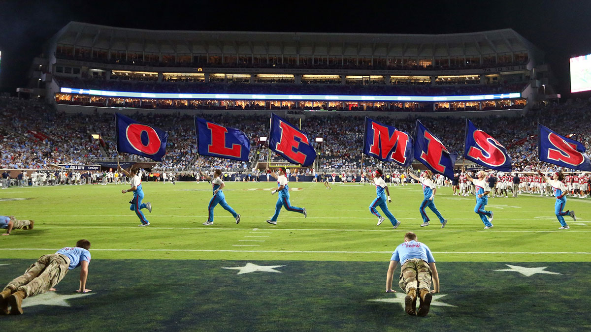 Mississippi Rebels Cheerleaders run the Ole Miss flags across the field after a touchdown during the second half against the Georgia Southern Eagles at Vaught-Hemingway Stadium.