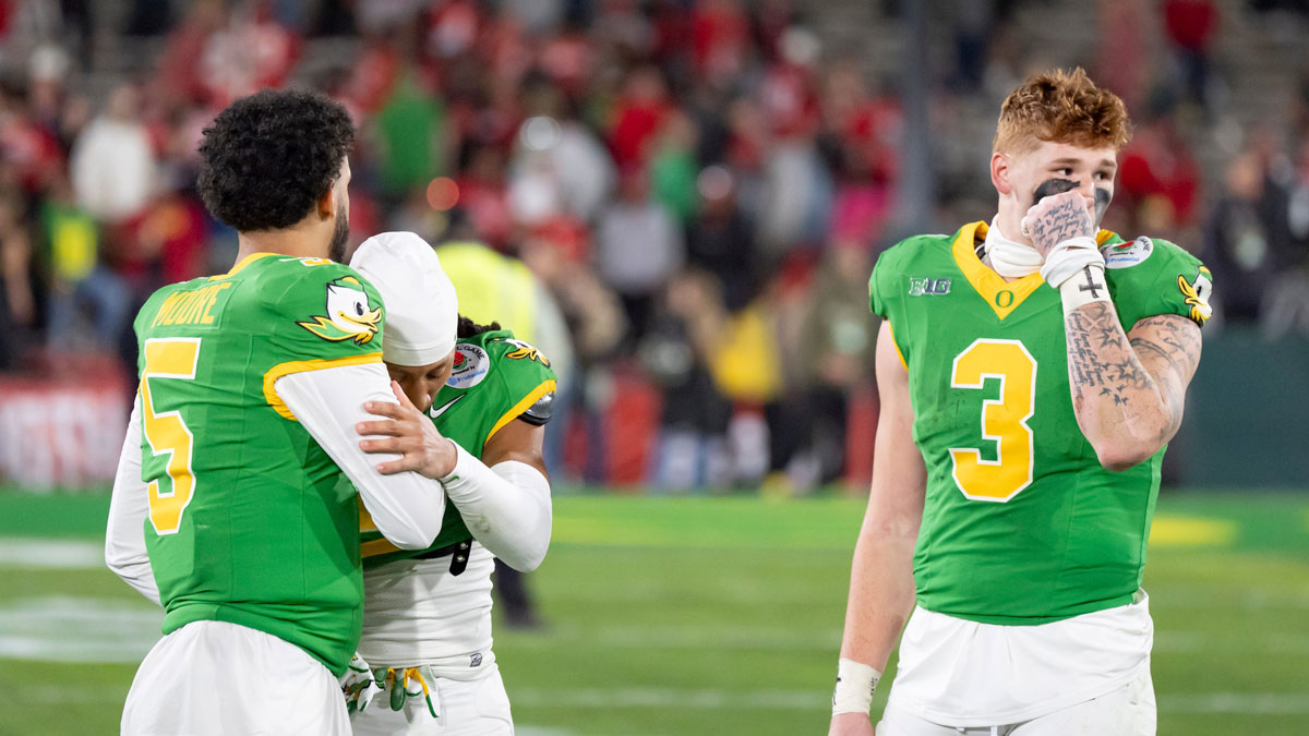 Oregon quarterback Dante Moore, left, defensive back Brandon Johnson and tight end Terrance Ferguson walk off the field as the Oregon Ducks face the Ohio State Buckeyes Wednesday, Jan. 1, 2025, in the quarterfinal of the College Football Playoff at the Rose Bowl in Pasadena, Calif.
