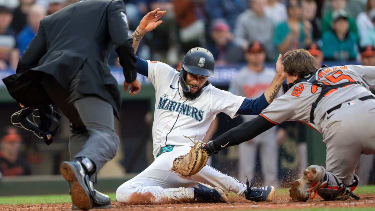 Seattle Mariners shortstop J.P. Crawford (3) is tagged out by Balitimore Orioles catcher Adley Rutschman (35) during the sixth inning at T-Mobile Park.