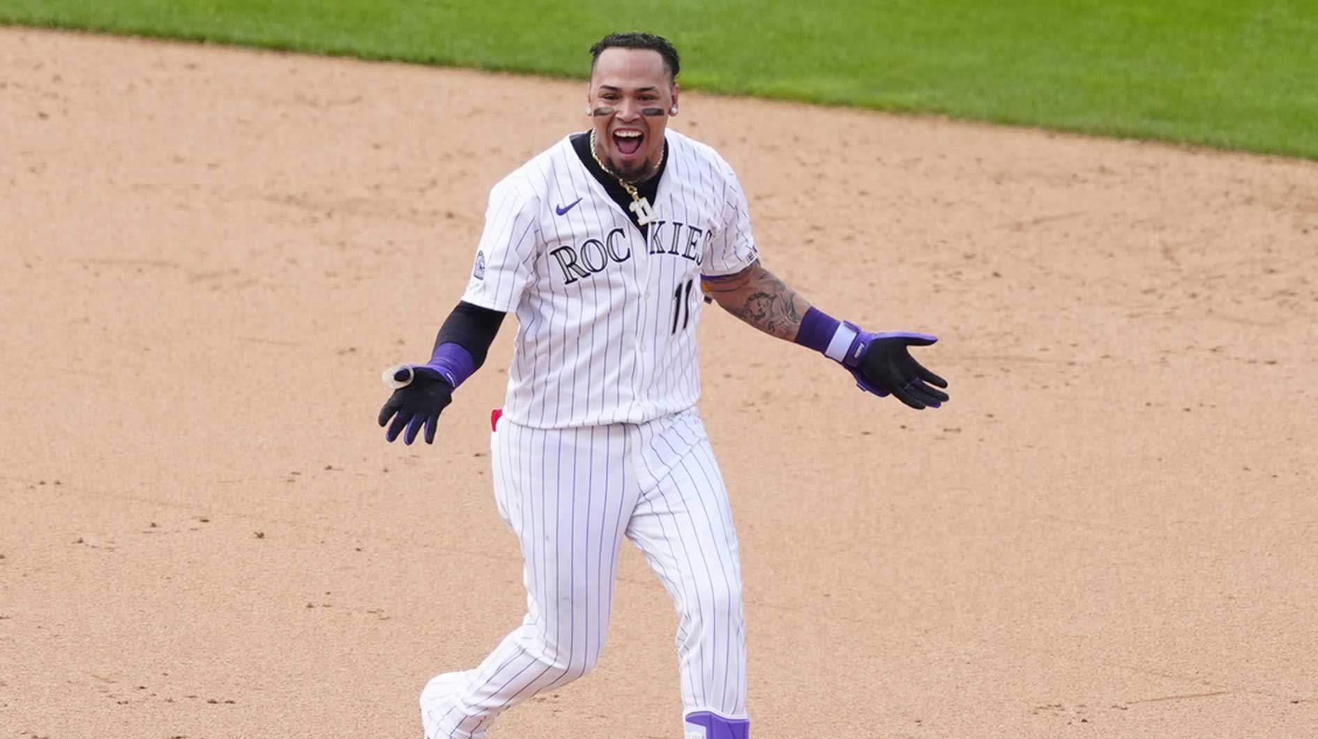 Colorado Rockies first baseman Orlando Arcia (11) celebrates his two run walk off single in the ninth inning against the San Francisco Giants.