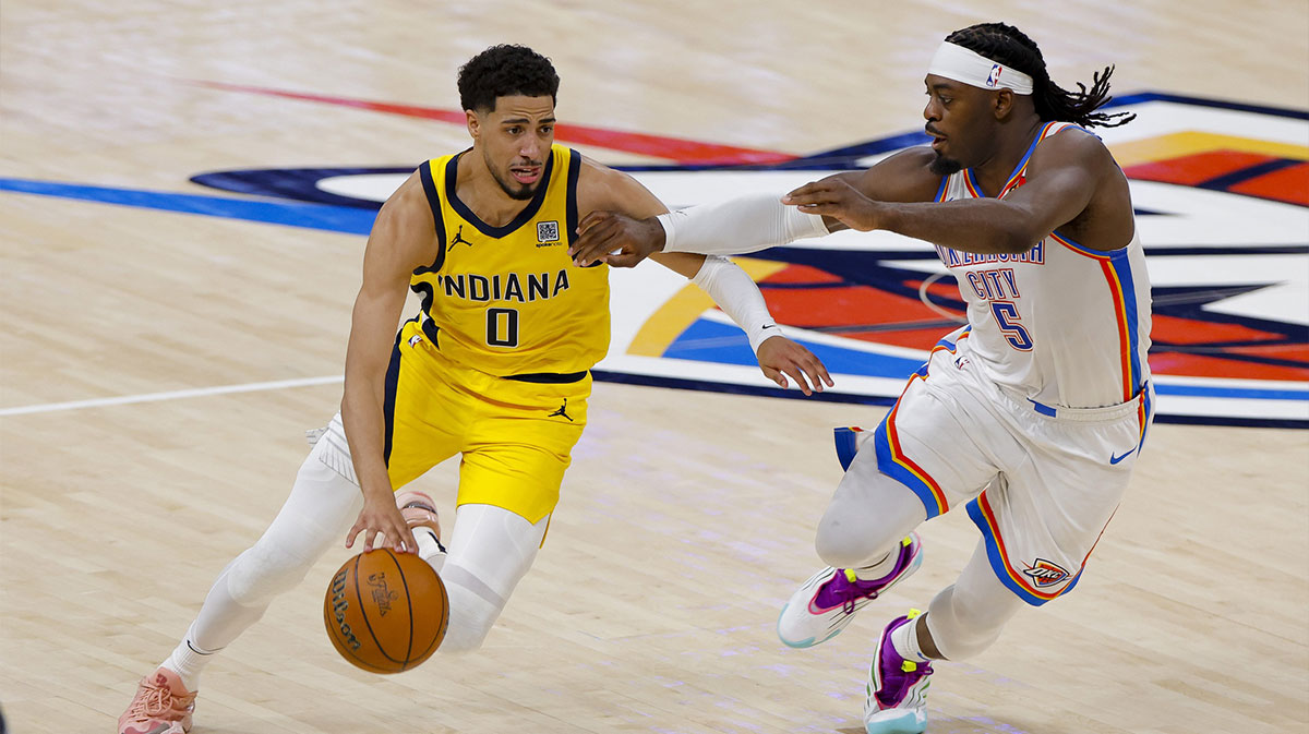 Indiana Pacers guard Tyrese Haliburton (0) drives to the basket past Oklahoma City Thunder guard Luguentz Dort (5) during the second quarter during game one of the 2025 NBA Finals at Paycom Center.