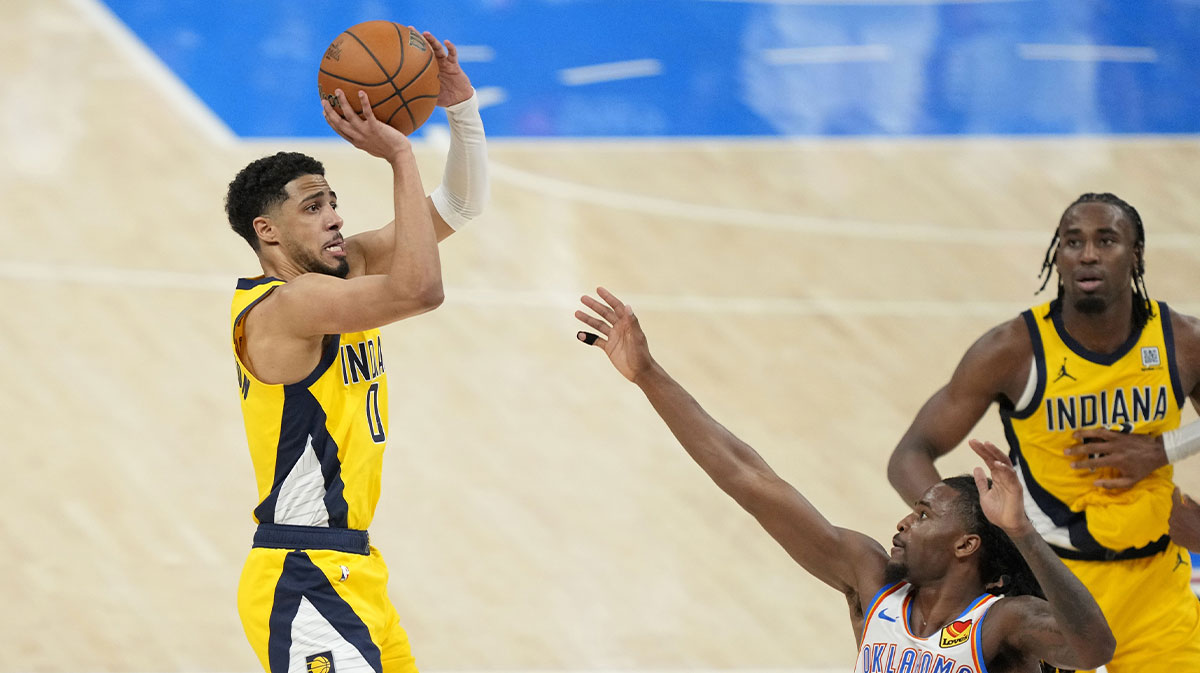 Indiana Pacers guard Tyrese Haliburton (0) shoots the ball against Oklahoma City Thunder guard Cason Wallace (22) during the fourth quarter in game one of the 2025 NBA Finals at Paycom Center.