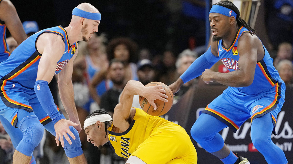Pacers guard Andrew Nembhard (2) falls with the ball