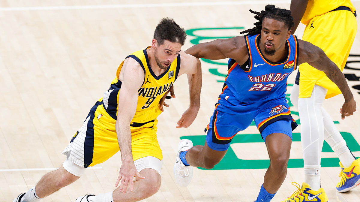 Indiana Pacers guard T.J. McConnell (9) dribbles the ball against Oklahoma City Thunder guard Cason Wallace (22) during the second half of game seven of the 2025 NBA Finals at Paycom Center.