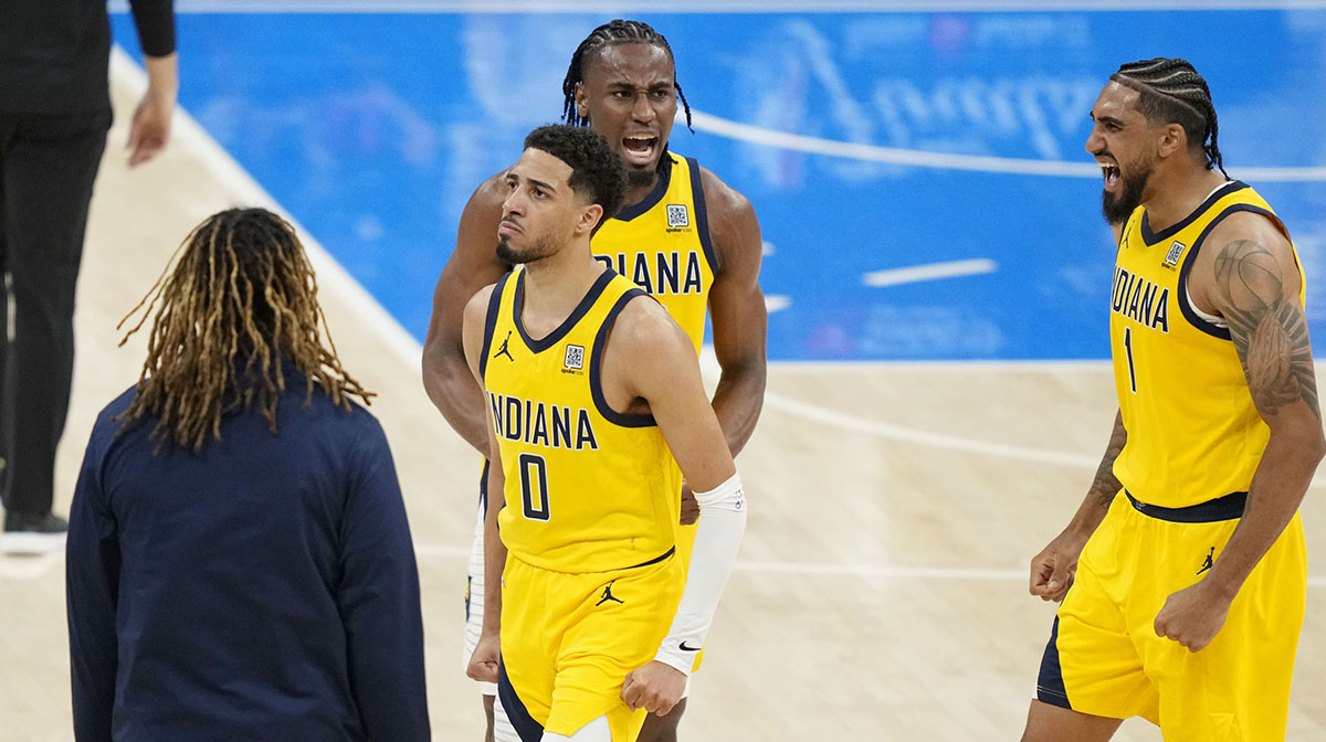 Pacers guard Tyrese Haliburton (0), forward Aaron Nesmith (center) and forward Obi Toppin (1) react after a play against the Oklahoma City Thunder in game one of the 2025 NBA Finals at Paycom Center