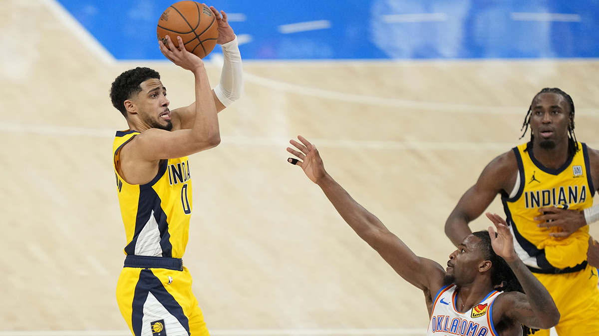 Pacers guard Tyrese Haliburton (0) shoots the ball against Oklahoma City Thunder guard Cason Wallace (22) during the fourth quarter in game one of the 2025 NBA Finals at Paycom Center