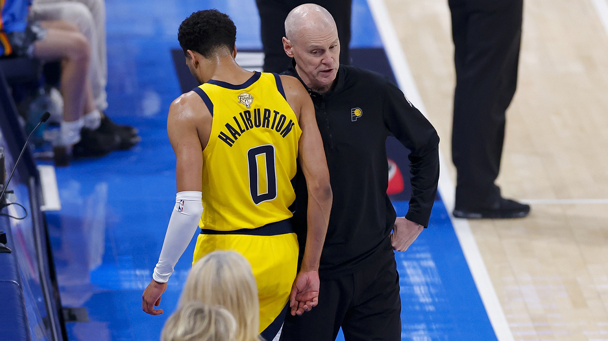 Pacers guard Tyrese Haliburton (0) comes off the floor past head coach Rick Carlisle in the first quarter against the Oklahoma City Thunder during game five of the 2025 NBA Finals at Paycom Center