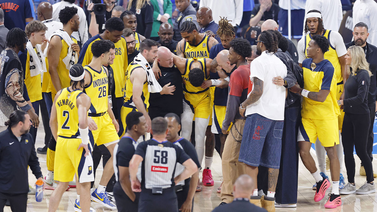 Indiana Pacers guard Tyrese Haliburton (0) is assisted after an apparent injury following a play against the Oklahoma City Thunder during the first half of game seven of the 2025 NBA Finals at Paycom Center.