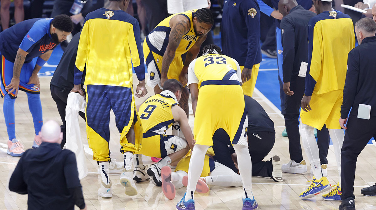 Indiana Pacers guard Tyrese Haliburton (0) is checked on after an apparent injury following a play against the Oklahoma City Thunder during the first half of game seven of the 2025 NBA Finals at Paycom Center.