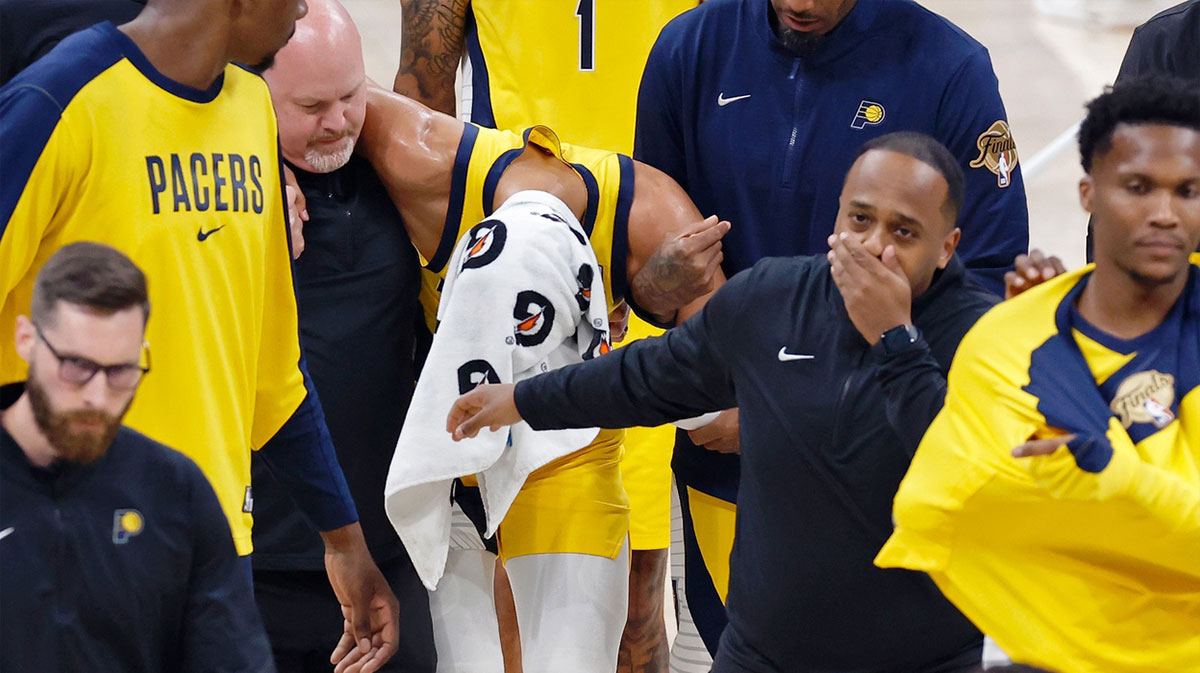 Indiana Pacers guard Tyrese Haliburton (0) is assisted after an apparent injury following a play against the Oklahoma City Thunder during the first half of game seven of the 2025 NBA Finals at Paycom Center.