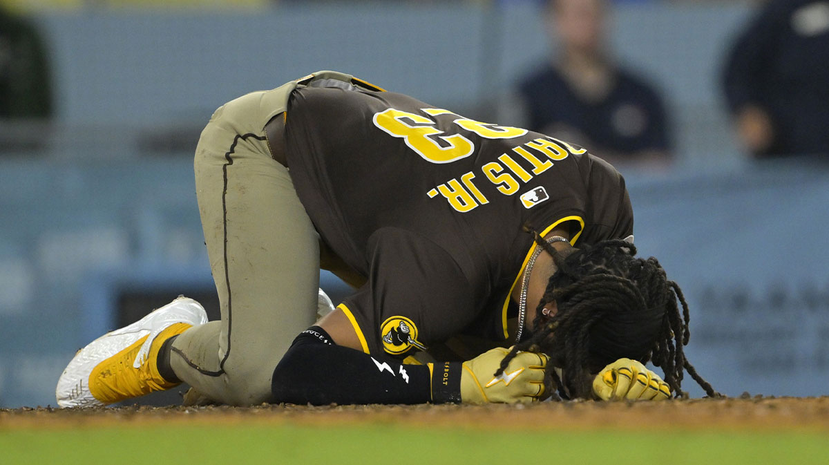 ; San Diego Padres right fielder Fernando Tatis Jr. (23) reacts as he is hit by a pitch in the eighth inning against the Los Angeles Dodgers at Dodger Stadium.