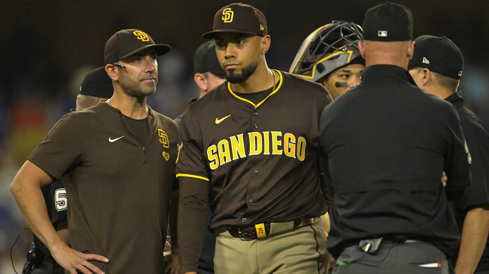 ; San Diego Padres bench coach Brian Esposito (82) looks on as elief pitcher Robert Suarez (75) is ejected from the game after hitting Los Angeles Dodgers designated hitter Shohei Ohtani (17) with a pitch in the ninth inning at Dodger Stadium.