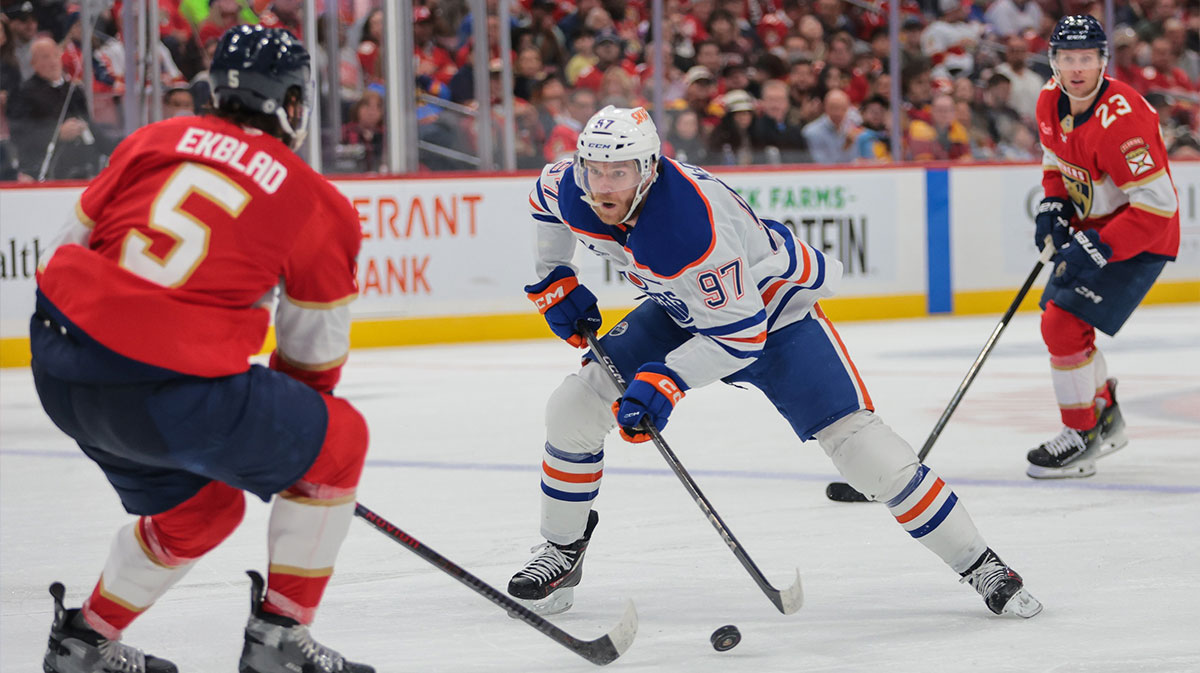 Edmonton Oilers center Connor McDavid (97) moves the puck as Florida Panthers defenseman Aaron Ekblad (5) defends during the first period at Amerant Bank Arena.