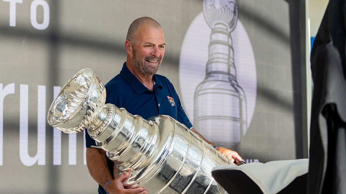 Panthers General Manager Bill Zito places the Stanley Cup on a table on Wednesday August 14, 2024 at Fiserv Forum in Milwaukee, Wis.