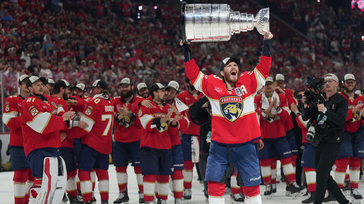 Florida Panthers left wing Matthew Tkachuk (19) hoist the Stanley Cup after game six of the 2025 Stanley Cup Final against the Edmonton Oilers at Amerant Bank Arena.