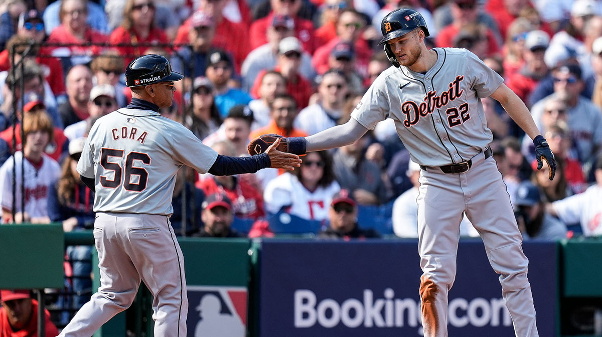Detroit Tigers center fielder Parker Meadows (22) shakes hands with third base coach Joey Cora (56) after stealing the third base against Cleveland Guardians during the second inning at Game 5 of ALDS at Progressive Field