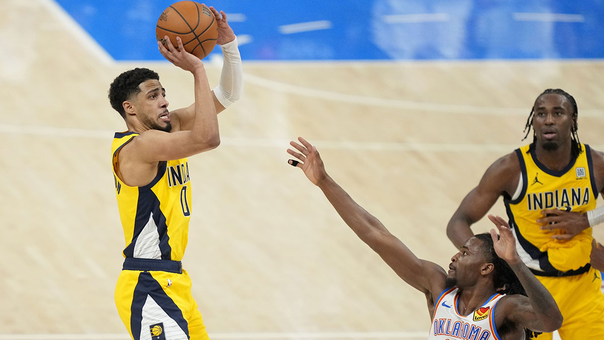 Indiana Pacers guard Tyrese Haliburton (0) shoots the ball against Oklahoma City Thunder guard Cason Wallace (22) during the fourth quarter in game one of the 2025 NBA Finals at Paycom Center.