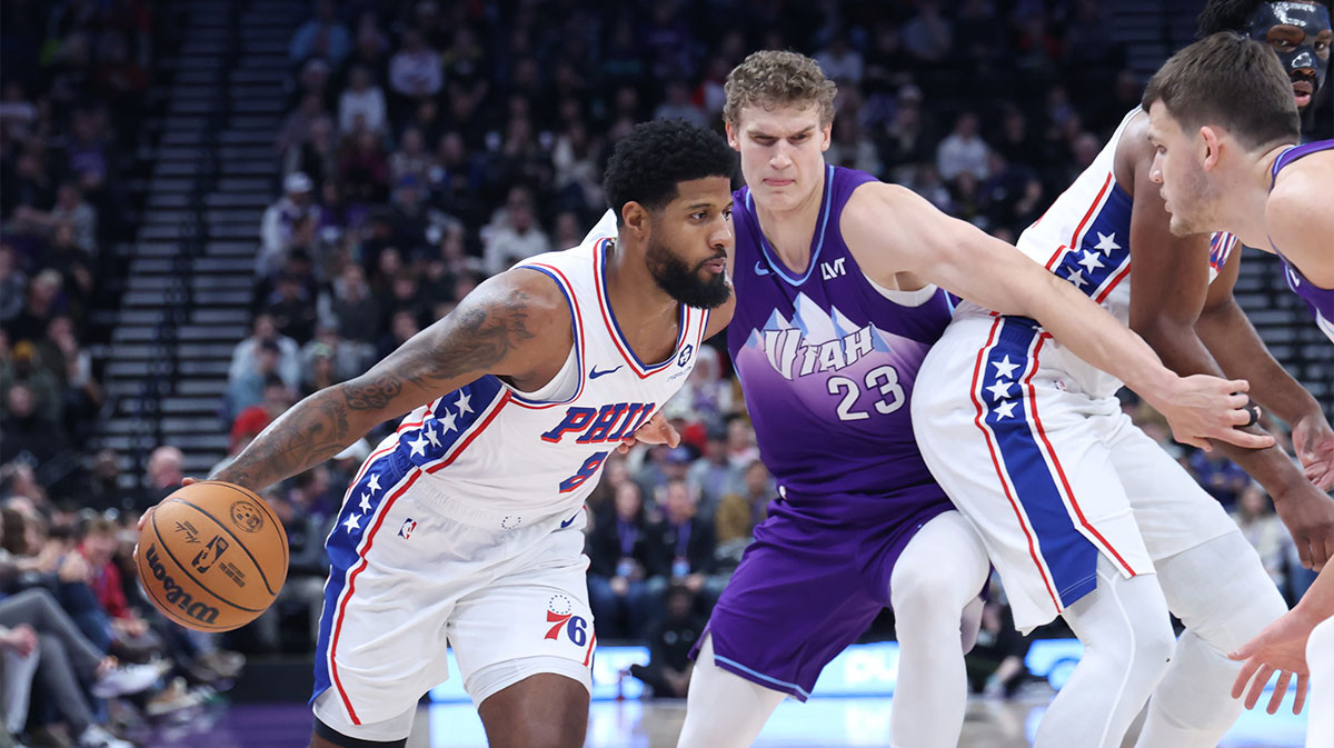 Philadelphia 76ers forward Paul George (8) dribbles against Utah Jazz forward Lauri Markkanen (23) during the first quarter at Delta Center.