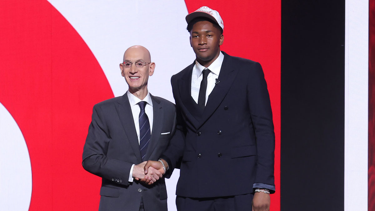 Pelicans' Derik Queen stands with NBA commissioner Adam Silver after being selected as the 13th pick by the Atlanta Hawks in the first round of the 2025 NBA Draft at Barclays Center with Pelicans' Joe Dumars in the background