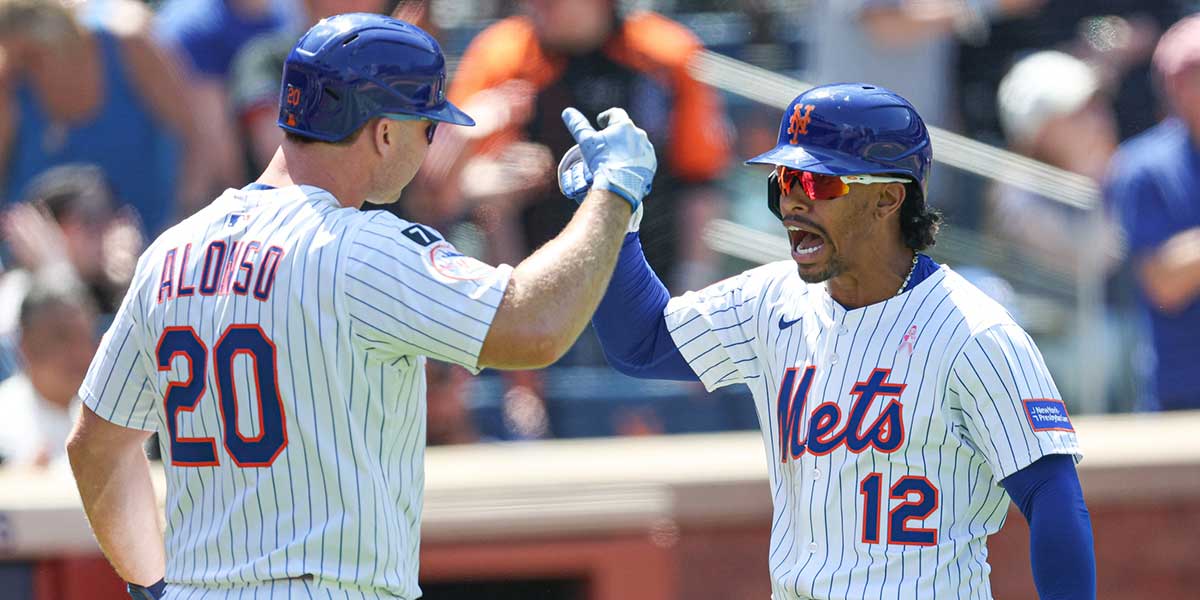 New York Mets shortstop Francisco Lindor (12) celebrates with first baseman Pete Alonso (20) after hitting a solo home run during the eighth inning against the Chicago Cubs at Citi Field.