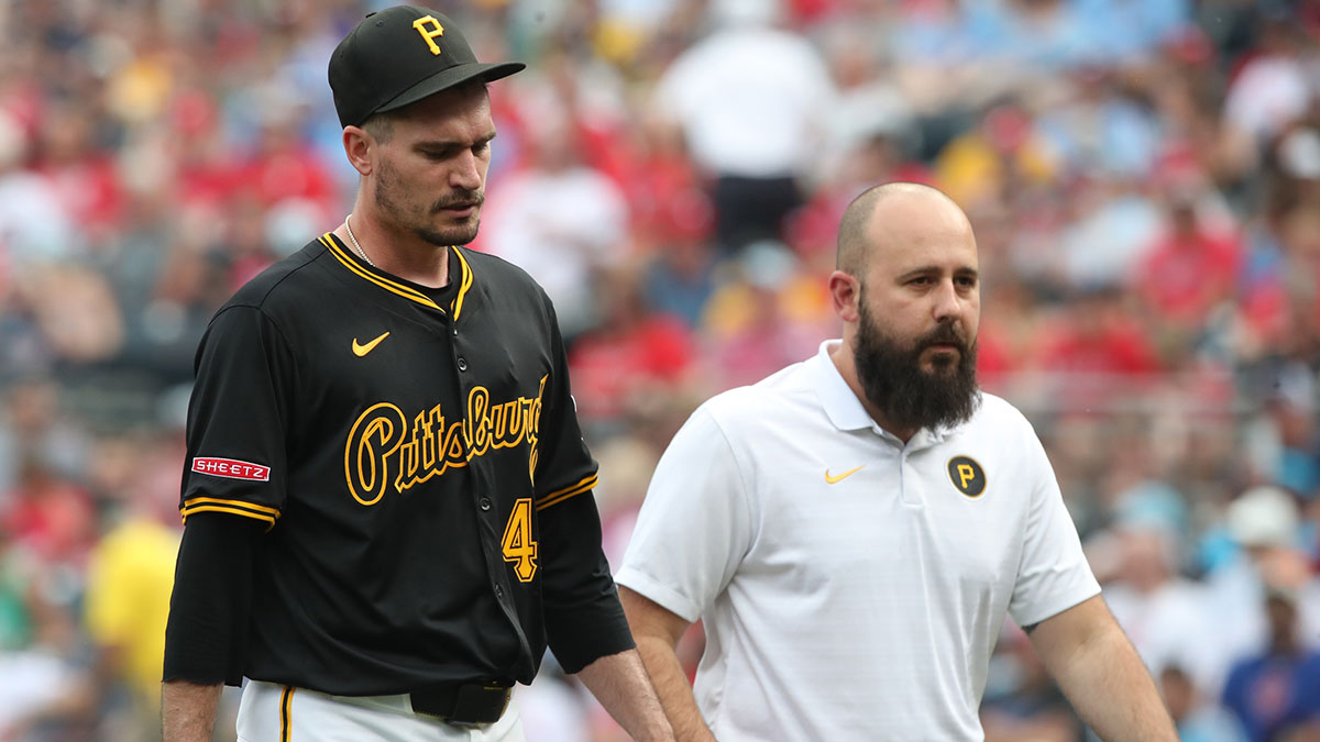 Pittsburgh Pirates starting pitcher Andrew Heaney (45) exits the game with trainer Rafael Freitas (right) after Heaney suffered an apparent injury pitching against the Philadelphia Phillies during the seventh inning at PNC Park.