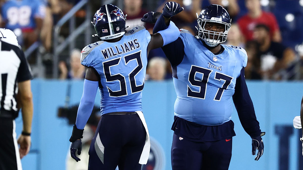 Aug 17, 2024; Nashville, Tennessee, USA; Tennessee Titans linebacker James Williams (52) and defensive tackle Quinton Bohanna (97) celebrate a successful stop in the fourth quarter against the Seattle Seahawks at Nissan Stadium. Mandatory Credit: Casey Gower-Imagn Images