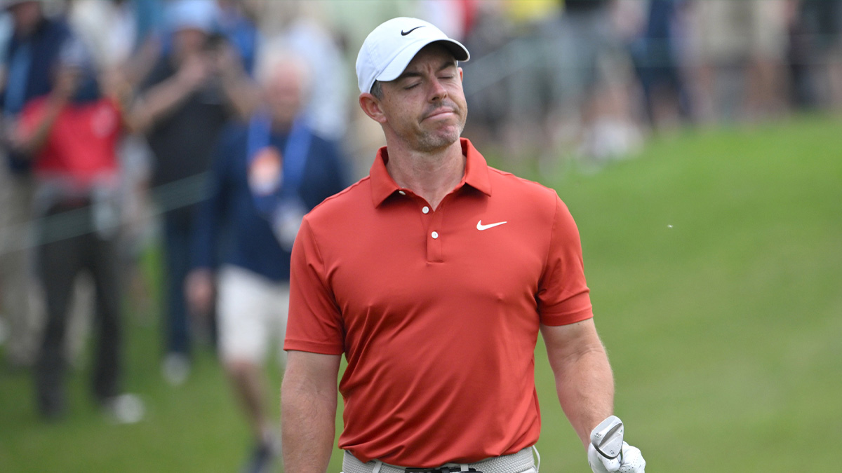 Rory McIlroy reacts after playing a bunker shot on the first hole during the second round of the RBC Canadian Open golf tournament