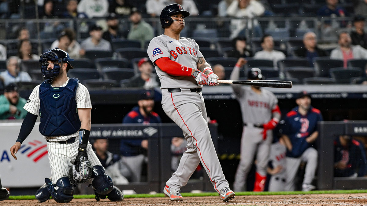 Boston Red Sox designated hitter Rafael Devers (11) reacts after hitting a solo home run against the New York Yankees during the ninth inning at Yankee Stadium.