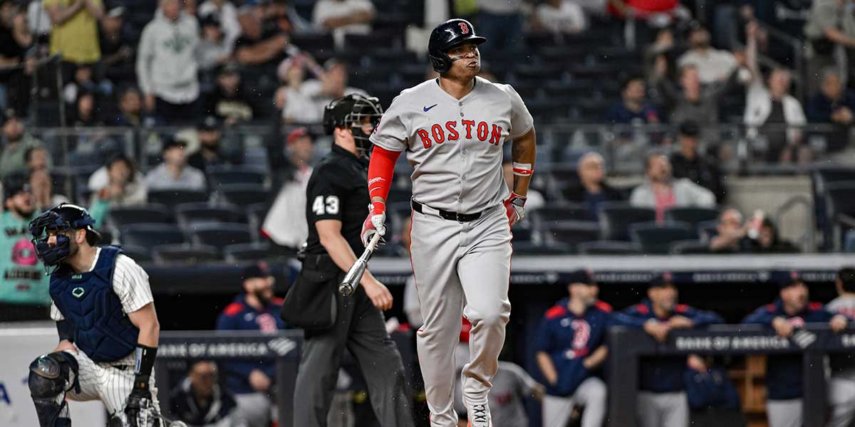 Boston Red Sox designated hitter Rafael Devers (11) reacts after hitting a solo home run against the New York Yankees during the ninth inning at Yankee Stadium.