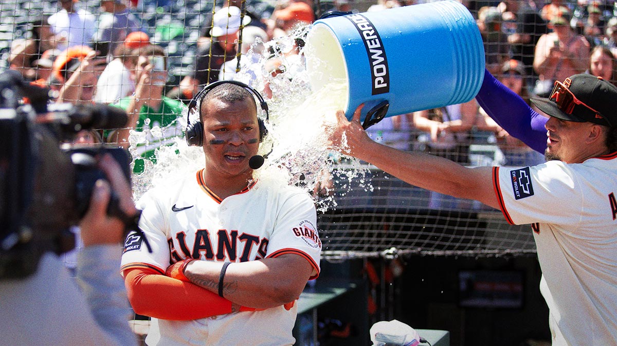 San Francisco Giants shortstop Willy Adames (right) douses teammate Rafael Devers following their victory over the Boston Red Sox at Oracle Park.