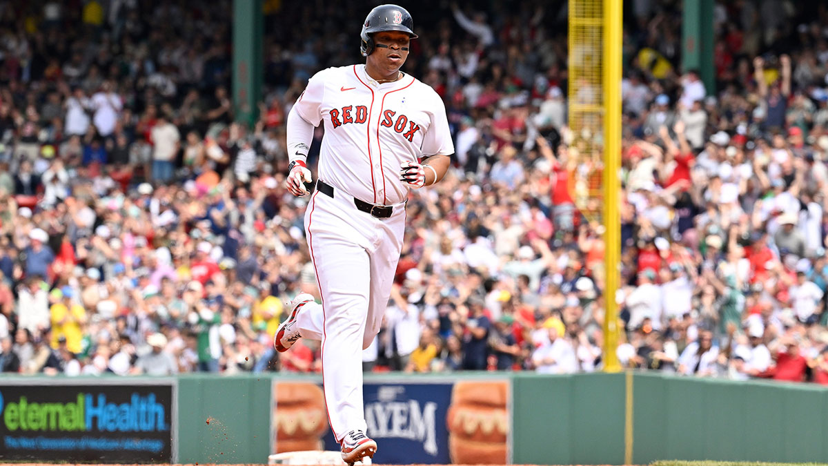 Boston Red Sox designated hitter Rafael Devers (11) runs the bases after hitting a one run home run against the New York Yankees during the fifth inning at Fenway Park.