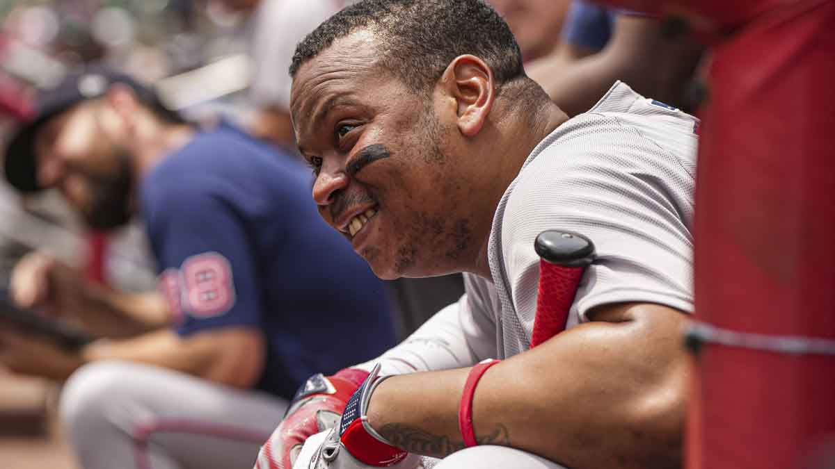 Boston Red Sox designated hitter Rafael Devers (11) watches a promotion on the scoreboard during the game against the Atlanta Braves at Truist Park.