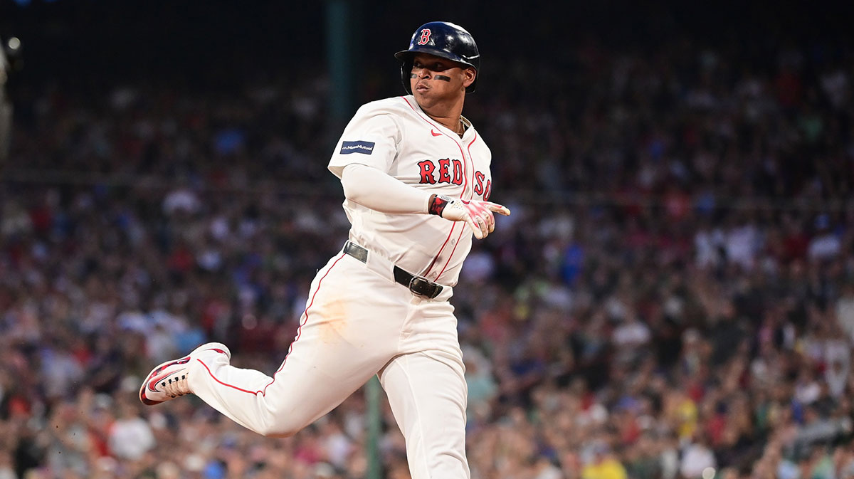 Boston Red Sox third baseman Rafael Devers (11) scores a run off an RBI by left fielder Tyler O'Neill (17) (not pictured) during the third inning against the Seattle Mariners at Fenway Park.