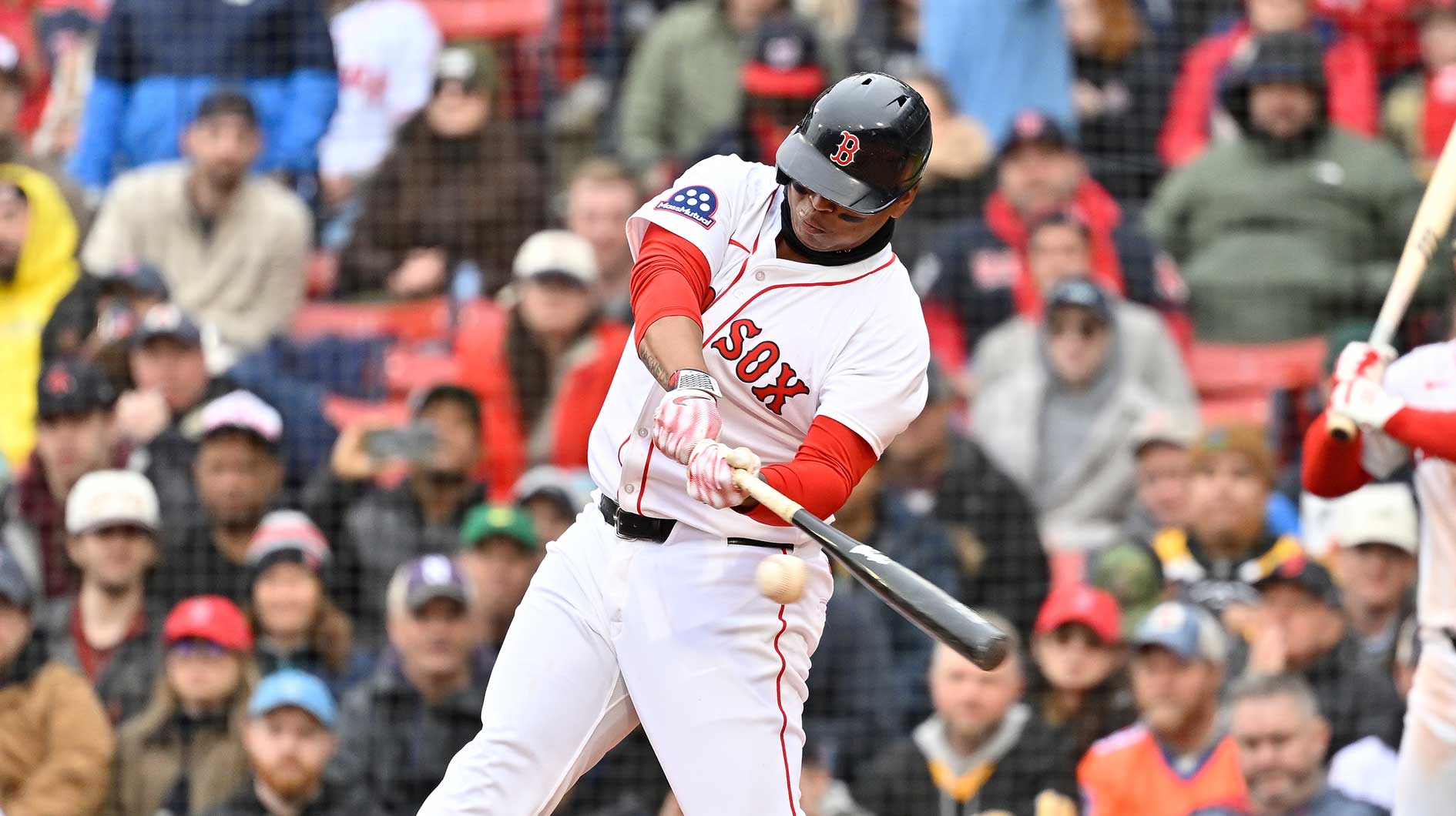 Boston Red Sox designated hitter Rafael Devers (11) hits a home run against the St. Louis Cardinals during the fifth inning at Fenway Park.