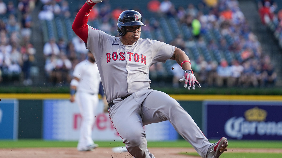 Boston Red Sox designated hitter Rafael Devers (11) slides into third base against Detroit Tigers during the first inning.