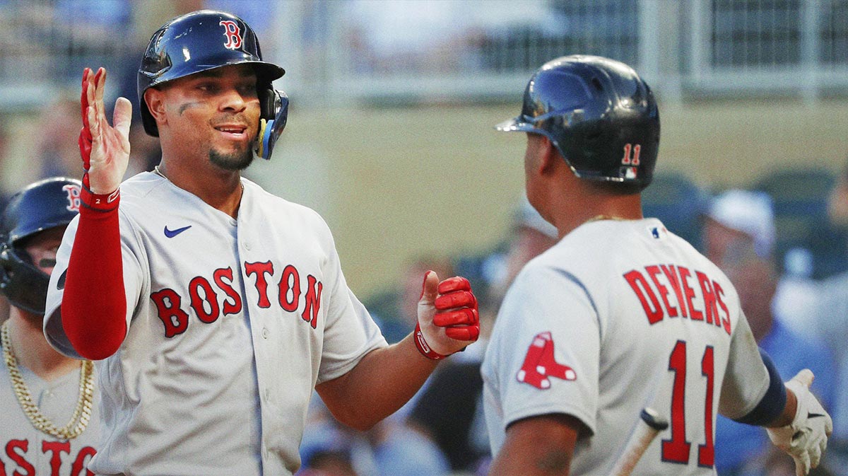 Boston Red Sox shortstop Xander Bogaerts (left) celebrates his grand slam home run against the Minnesota Twins with third baseman Rafael Devers (11) in the third inning at Target Field.