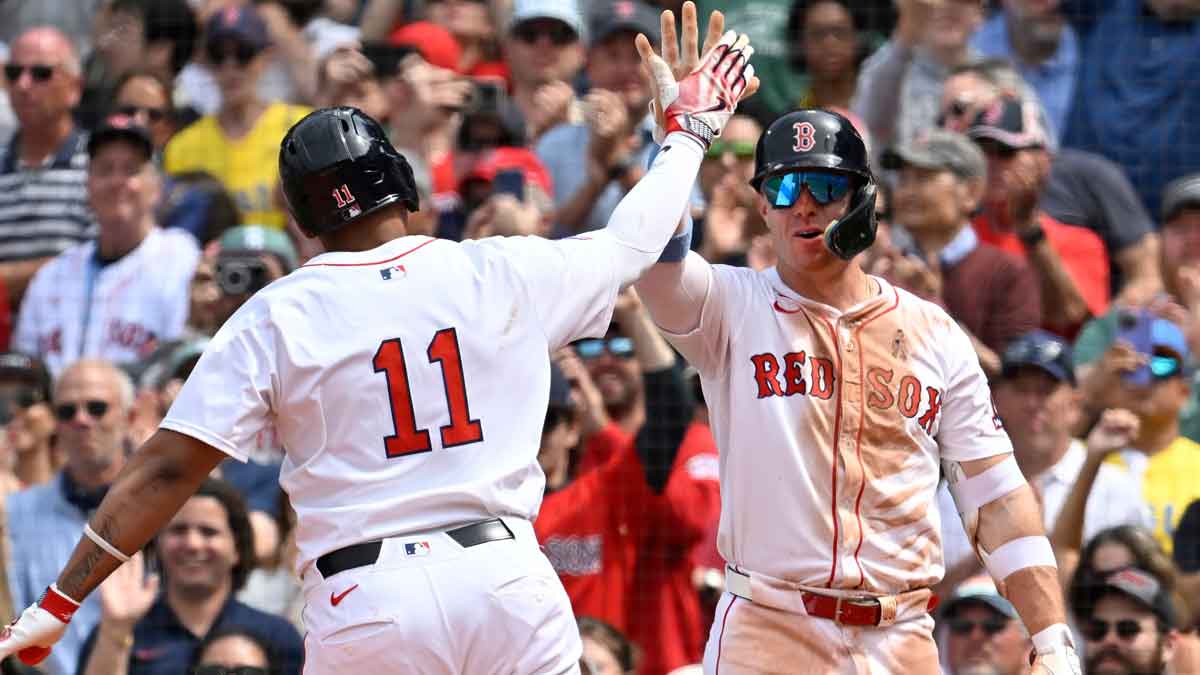 Boston Red Sox first baseman Romy Gonzalez (23) reacts to designated hitter Rafael Devers' (11) one run home run during the fifth inning against the New York Yankees at Fenway Park.