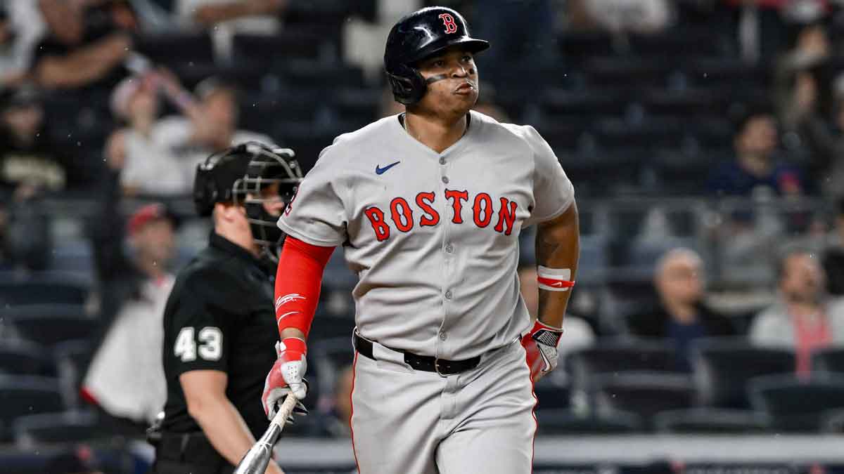 Boston Red Sox designated hitter Rafael Devers (11) reacts after hitting a solo home run against the New York Yankees during the ninth inning at Yankee Stadium.