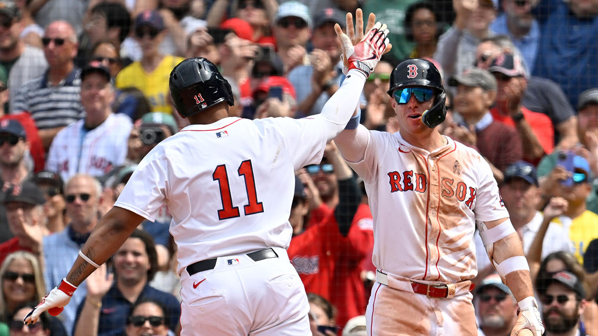 Boston Red Sox first baseman Romy Gonzalez (23) reacts to designated hitter Rafael Devers' (11) one run home run during the fifth inning against the New York Yankees at Fenway Park.