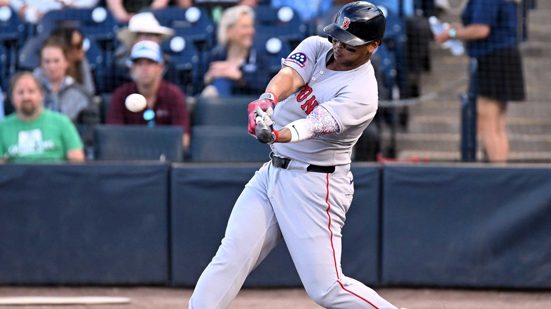 Boston Red Sox designated hitter Rafael Devers hits a double in the first inning against the Tampa Bay Rays. All players wore number 42 for Jackie Robinson Day at George M. Steinbrenner Field.