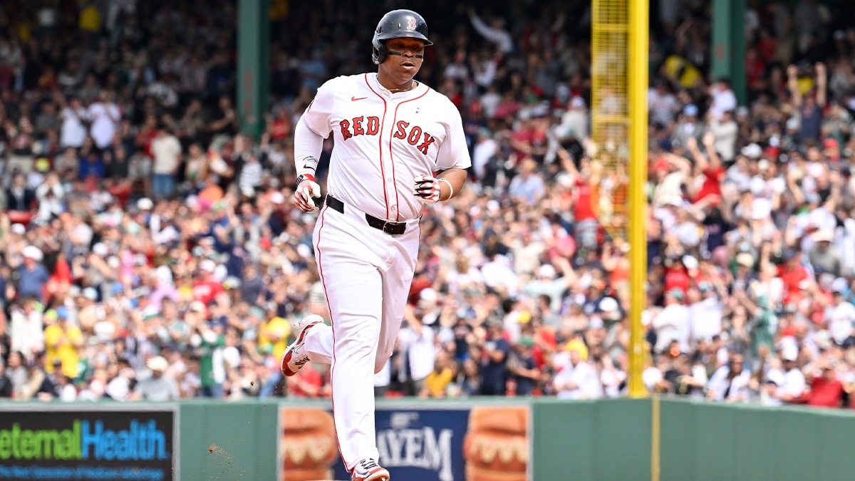 Boston Red Sox designated hitter Rafael Devers (11) runs the bases after hitting a one run home run against the New York Yankees during the fifth inning at Fenway Park.