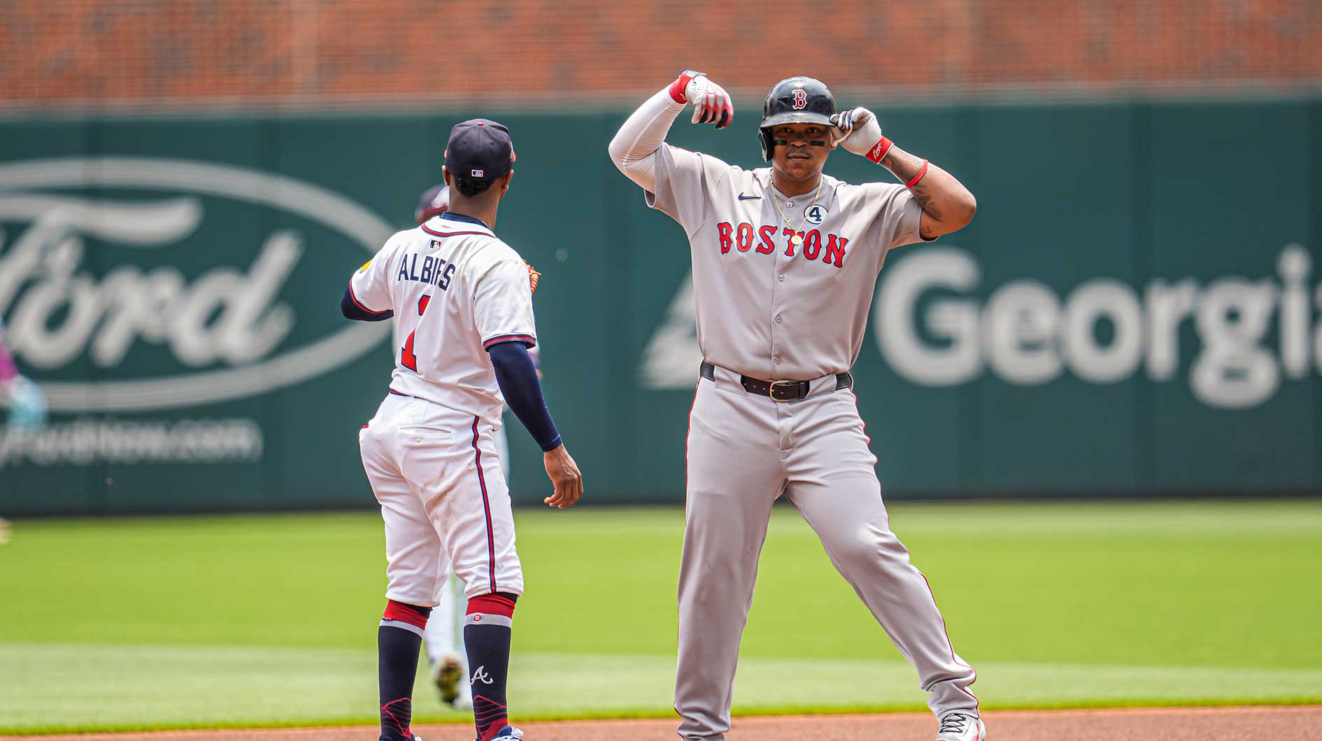 Boston Red Sox designated hitter Rafael Devers (11) reacts after hitting a double against the Atlanta Braves during the first inning at Truist Park