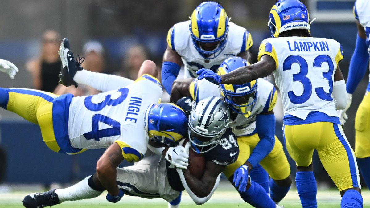 Dallas Cowboys wide receiver Kelvin Harmon (84) carries the ball against Los Angeles Rams safety Tanner Ingle (34) during the fourth quarter at SoFi Stadium.