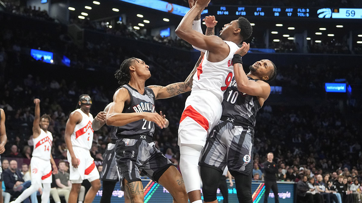 Toronto Raptors shooting guard RJ Barrett (9) shoots a jump shot against. Brooklyn Nets forward Noah Clowney (21) and Brooklyn Nets guard Tyson Eitenne (10) during the first half at Barclays Center.