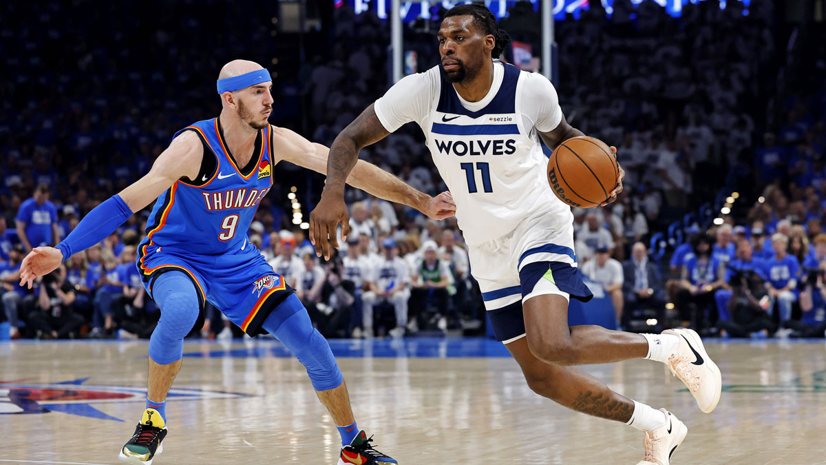Minnesota Timberwolves center Naz Reid (11) drives to the basket against Oklahoma City Thunder guard Alex Caruso (9) during the second quarter in game five of the western conference finals for the 2025 NBA Playoffs at Paycom Center