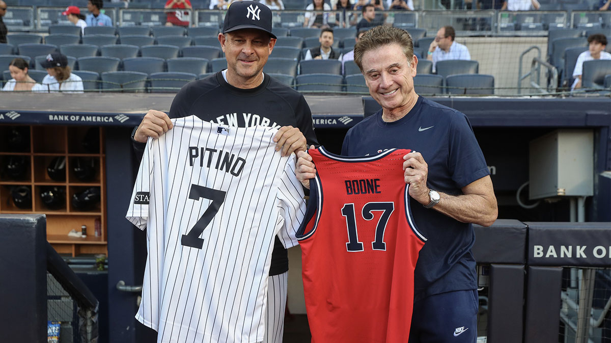 St. John’s Red Storm head coach Rick Pitino poses with New York Yankees manager Aaron Boone (17) at Yankee Stadium.